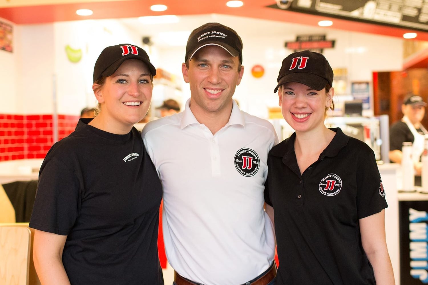 Jimmy John's franchise owner, Ben Stoltzfoos, with two employees