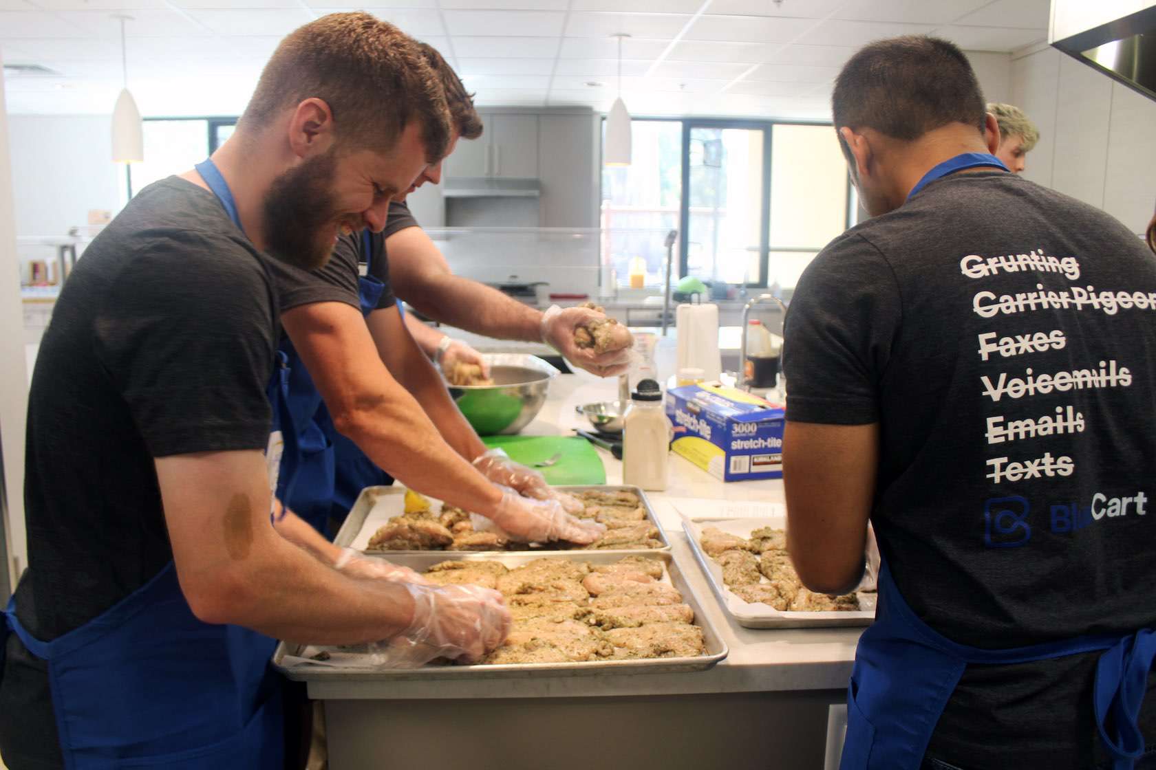 BlueCart employees preparing chicken at Ronald McDonald House Stanford